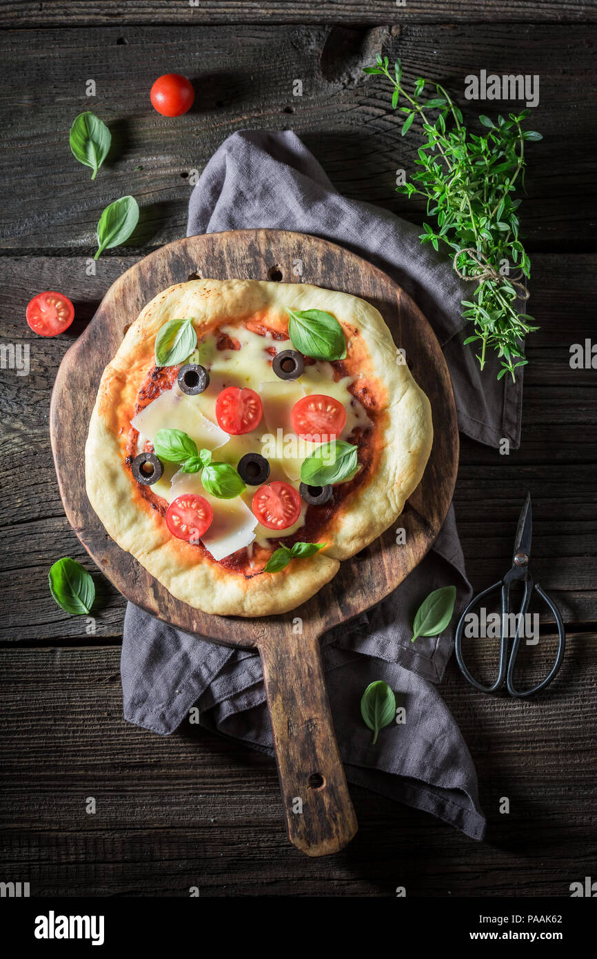 Homemade pizza with cheese, tomatoes and herbs Stock Photo Alamy
