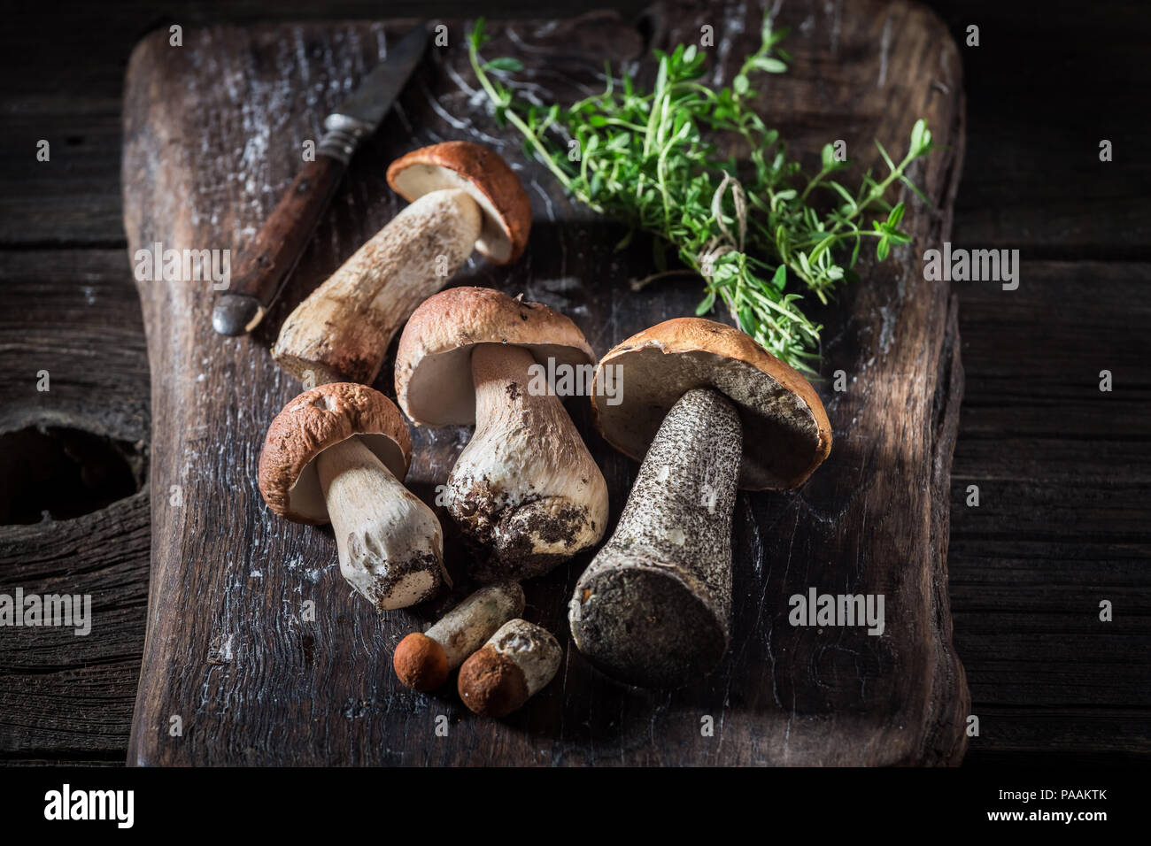 Wild mushrooms and herbs on the old board Stock Photo Alamy