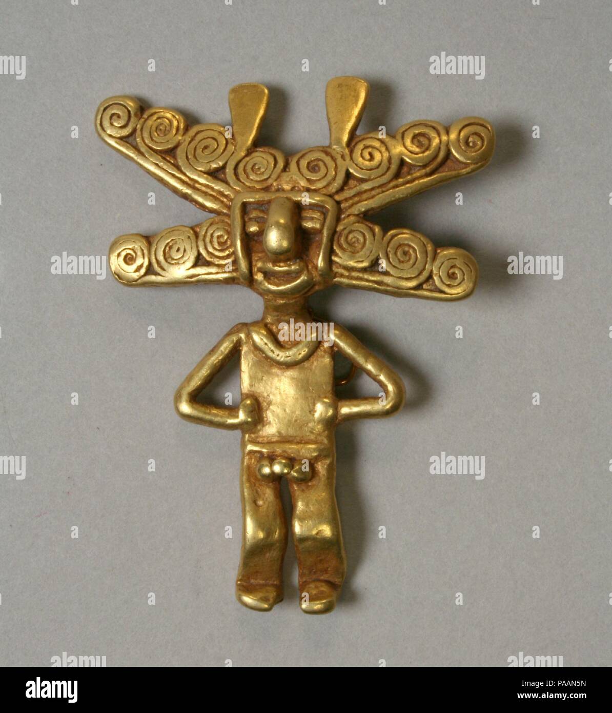 Gold Figure Pendant. Culture: Quimbaya (?). Dimensions: H. 1 3/4 x W. 1 3/8 x D. 3/8 in. (4.4 x 3.5 x 1 cm). Date: 5th-10th century. Museum: Metropolitan Museum of Art, New York, USA. Stock Photo