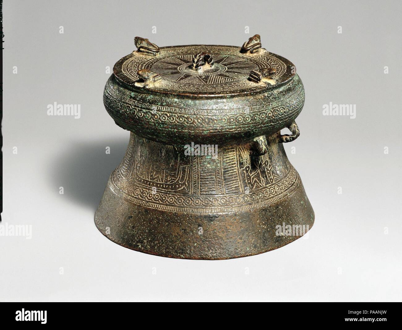 Miniature Drum with Four Frogs. Culture: Vietnam. Dimensions: H. 4 in. (10.2 cm). Date: ca. 500 B.C.-A.D. 300.  Ranging in height from a few inches to over six feet, up to four feet in diameter, and often of considerable weight, drums are the most widely dispersed products of the Dongson culture of northern Vietnam. Examples produced in Vietnam, in addition to works made locally, have been found in south China and throughout mainland  and island Southeast Asia. The function of these drums, often found in burials, remains unclear. They may have been used in warfare, as political regalia,  or as Stock Photo