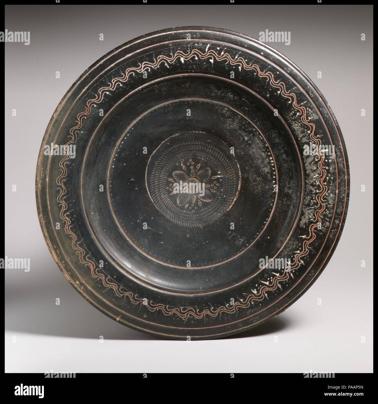 Terracotta dish. Culture: Greek, South Italian, Campanian, Teano. Dimensions: diameter  11 5/16in. (28.7cm). Date: ca. 330-300 B.C..  Stamped, incised and painted decorations. Museum: Metropolitan Museum of Art, New York, USA. Stock Photo