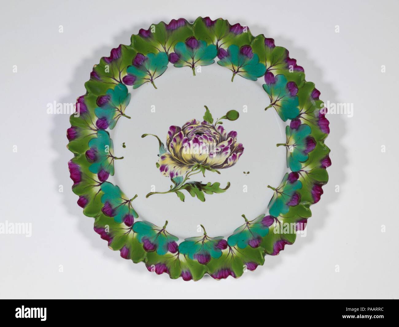 Plate. Culture: French, Sceaux. Dimensions: Diameter: 9 1/8 in. (23.2 cm). Date: ca. 1765-70.  Faience, or tin-glazed and enameled earthenware, first emerged in France during the sixteenth century, reaching widespread usage among elite patrons during the seventeenth and early eighteenth centuries, prior to the establishment of soft-paste porcelain factories. Although characterized as more provincial in style than porcelain, French faience was used at the court of Louis XIV as part of elaborate meals and displays, with large-scale vessels incorporated into the Baroque garden designs of Versaill Stock Photo