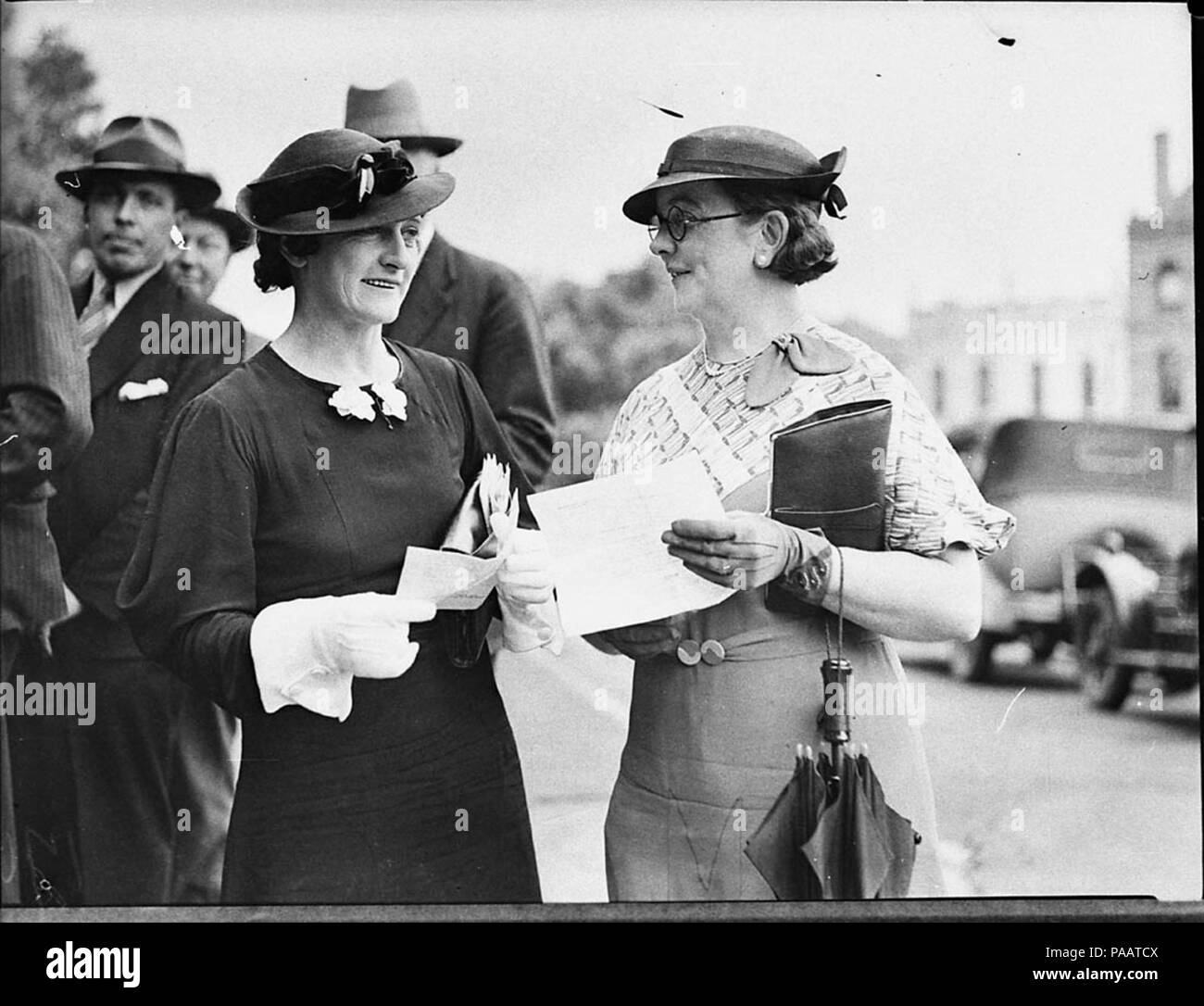 240 SLNSW 14182 Justices of the Peace sworn in Two women holding papers outside Court of Quarter Sessions Stock Photo