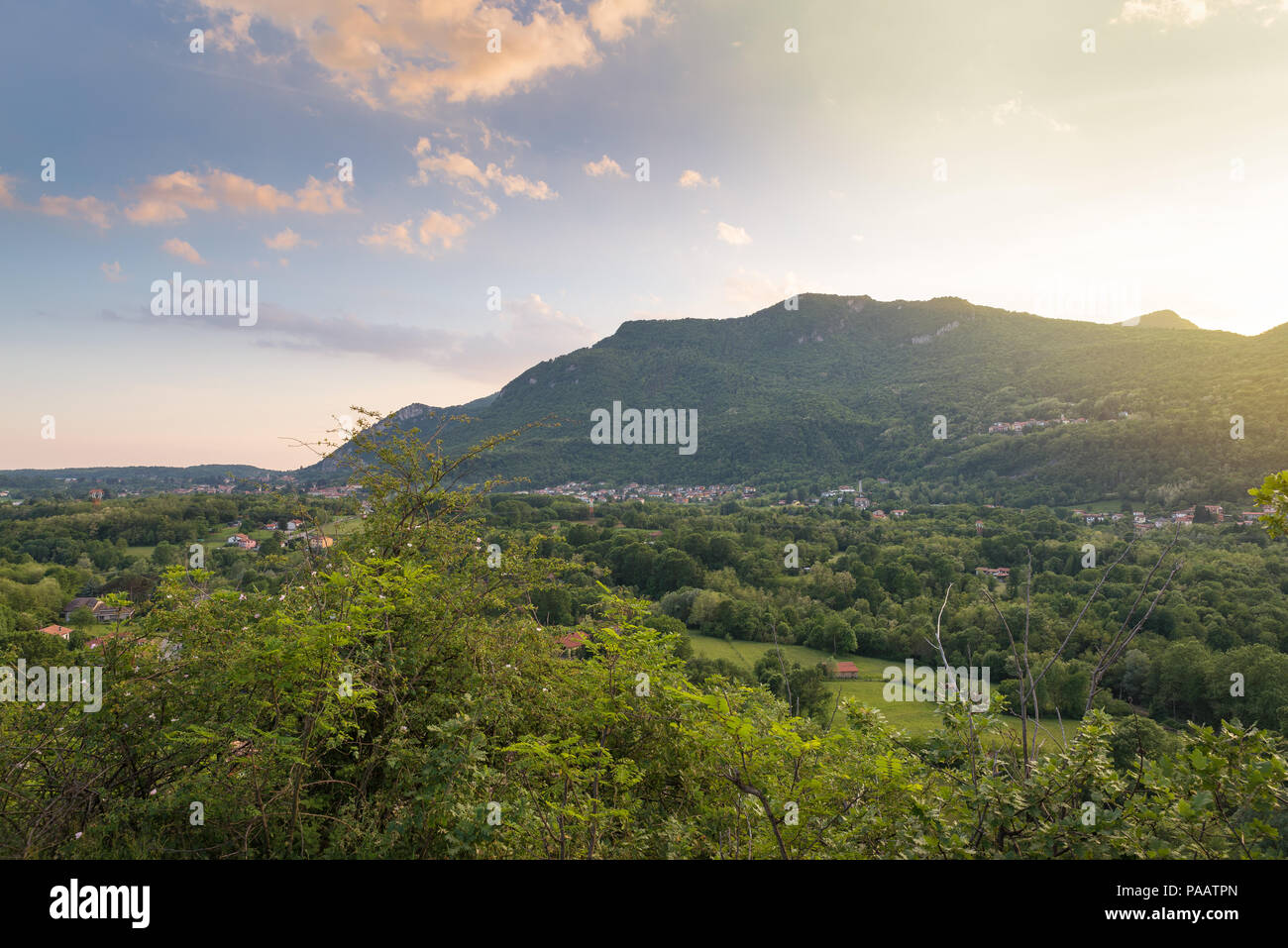 Italian landscape at sunset. Besano, province of Varese. In the background the Valceresio with on the left, town of Arcisate, in the center, Bisuschio Stock Photo