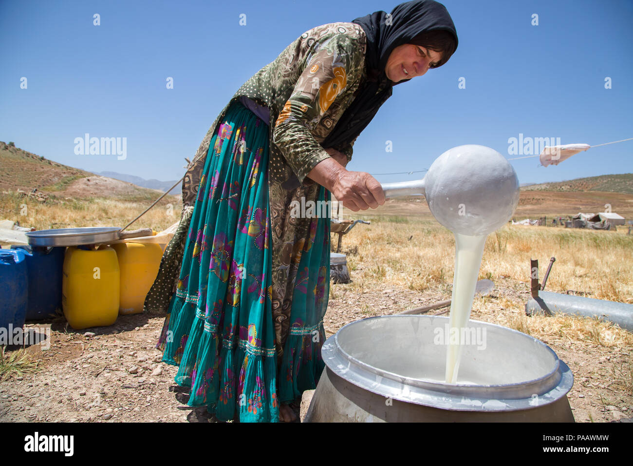 Qashqai woman boiling milk at camp, nomad people, Iran Stock Photo