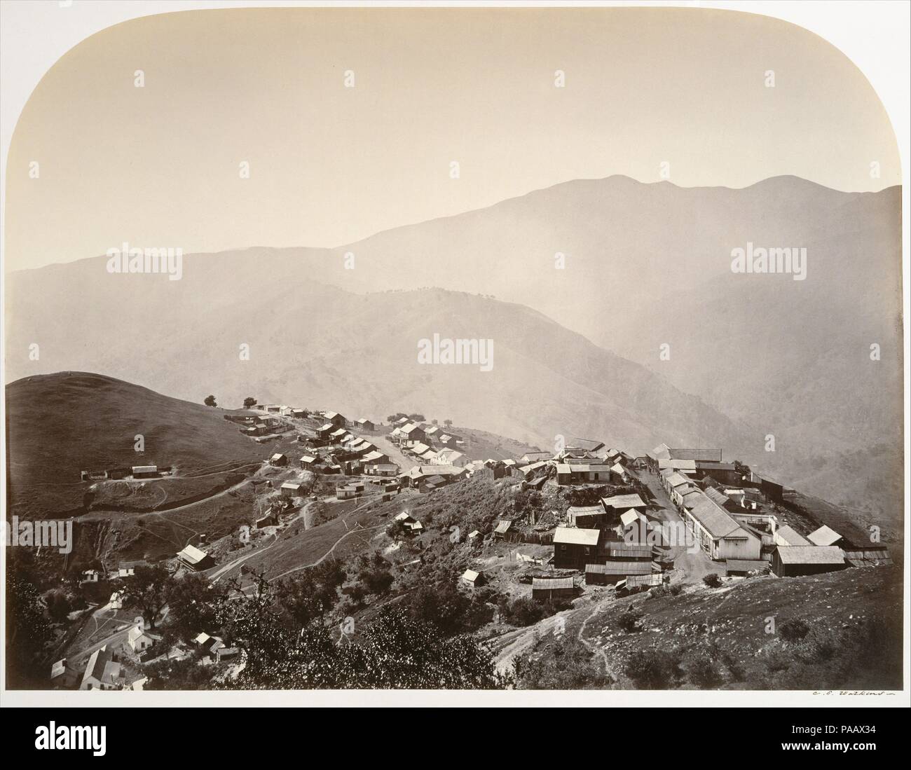 The Town on the Hill, New Almaden. Artist: Carleton E. Watkins (American, 1829-1916). Dimensions: 39.7 x 52.3 cm (15 5/8 x 20 9/16 in.). Date: 1863.  Watkins, the consummate photographer of the American West, combined a virtuoso mastery of the difficult wet-plate negative process with a rigorous sense of pictorial structure.  In 1863 he was hired to make a photographic survey of the quicksilver mining operations in New Almaden, near San Jose, California.  Quicksilver--used to bond with, and weigh down, the finest particles of gold that might otherwise float away in the sluicing process--was es Stock Photo