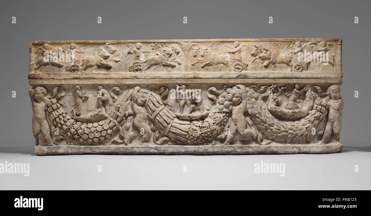 Marble sarcophagus with garlands and the myth of Theseus and Ariadne. Culture: Roman. Dimensions: Overall: 31 x 85 3/4 x 28in. (78.7 x 217.8 x 2.3 cm). Date: ca. A.D. 130-150.  On the lid, shown in delicate low relief, winged erotes drive chariots drawn by animals associated with the four seasons: bears with spring, lions with summer, bulls with fall, and boars with winter. On the front, four erotes bear seasonal garlands composed of flowers, wheat, grapes, pomegranates, and laurel. Between the swags are three episodes from the myth of the Greek hero Theseus. With the help of the Cretan prince Stock Photo