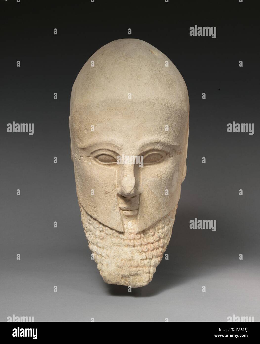 Limestone bearded head with a Corinthian helmet. Culture: Cypriot. Dimensions: Overall: 12 5/16 × 6 1/2 × 8 3/4 in. (31.3 × 16.5 × 22.2 cm). Date: early 5th century B.C.. Museum: Metropolitan Museum of Art, New York, USA. Stock Photo