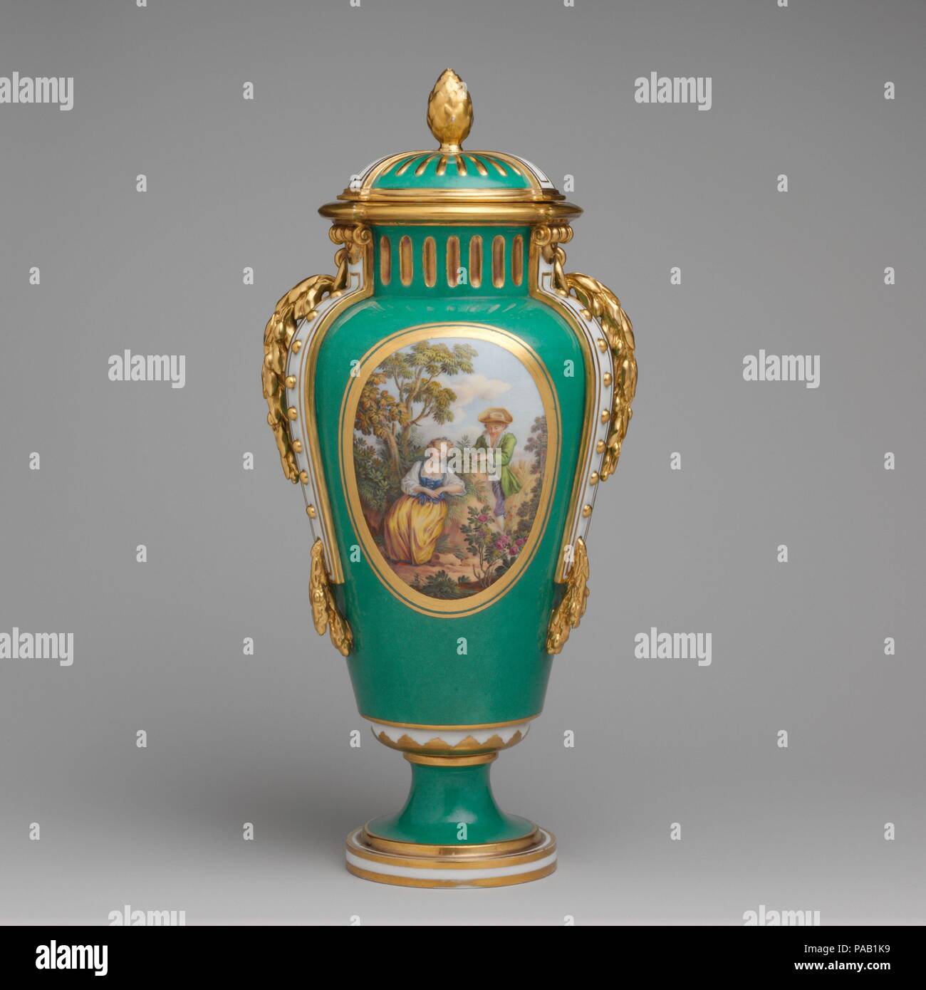 Vase with cover (vase à bandes) (one of a pair). Artist: After engravings by Louis Crépy (French); Based on a composition by Antoine Watteau (French, Valenciennes 1684-1721 Nogent-sur-Marne). Culture: French, Sèvres. Decorator: Gilded by Henry-Martin Prévost (French, active 1757-97); Figures by Charles Nicolas Dodin (French, Versailles 1734-1803 Sèvres). Dimensions: Height: 13 1/16 in. (33.2 cm). Factory: Sèvres Manufactory (French, 1740-present). Date: ca. 1770-75.  The bucolic scenes on the front of these vases (see also 58.75.69a, b) are after compositions by the French painter Jean-Antoine Stock Photo