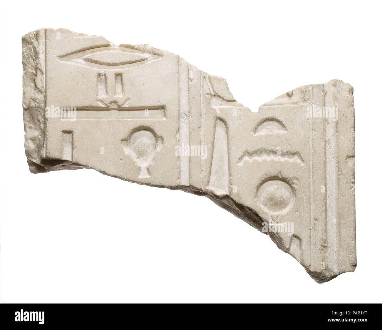 Back pillar fragment (?), Aten and Akhenaten named. Dimensions: H. 14.5 × W. 10 × D. 12 cm (5 11/16 × 3 15/16 × 4 3/4 in.); side edge of b.p. 4.5 cm before narrowing further, with rebate distance on either side of about 1.3 (p.l) -1.5(p.r.) cm to create a b.p. about 10 cm total width at its beginning (whole thing  inclines so as to narrow toward statue). Dynasty: Dynasty 18. Reign: reign of Akhenaten. Date: ca. 1353-1336 B.C.. Museum: Metropolitan Museum of Art, New York, USA. Stock Photo