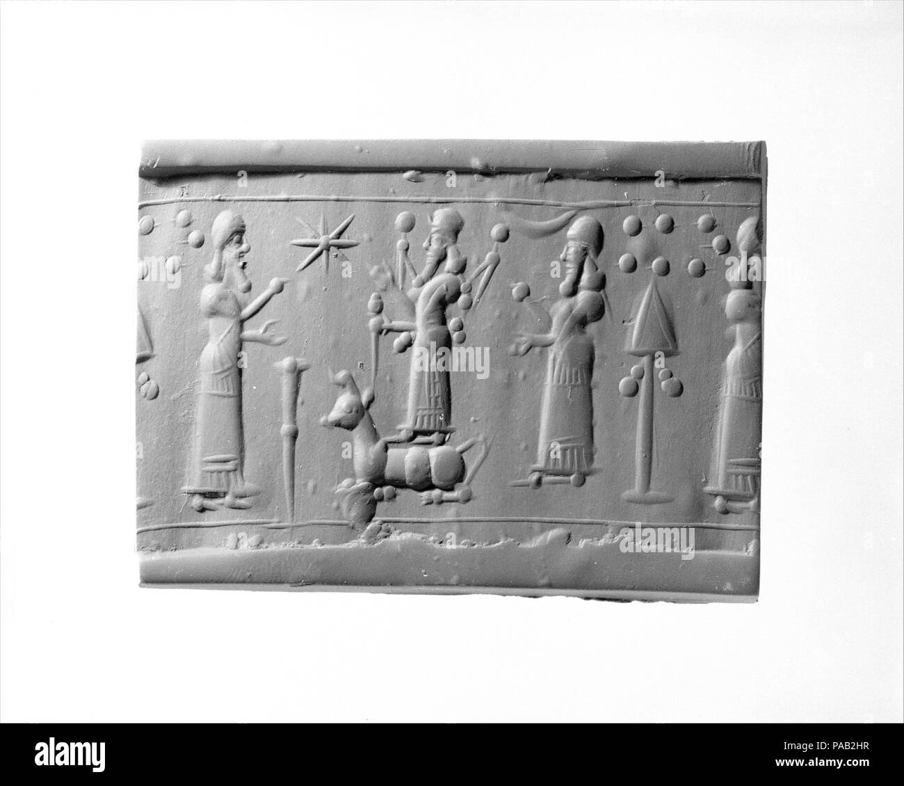 Cylinder seal. Culture: Assyrian. Dimensions: 1.54 in. (3.91 cm). Date: ca. 9th-8th century B.C.. Museum: Metropolitan Museum of Art, New York, USA. Stock Photo