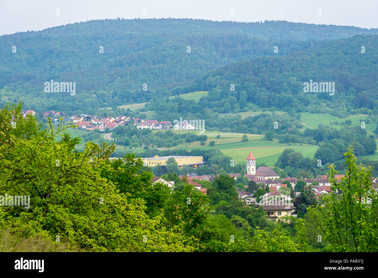 Germany, Little swabian village Rudersberg surrounded by green forest Stock Photo