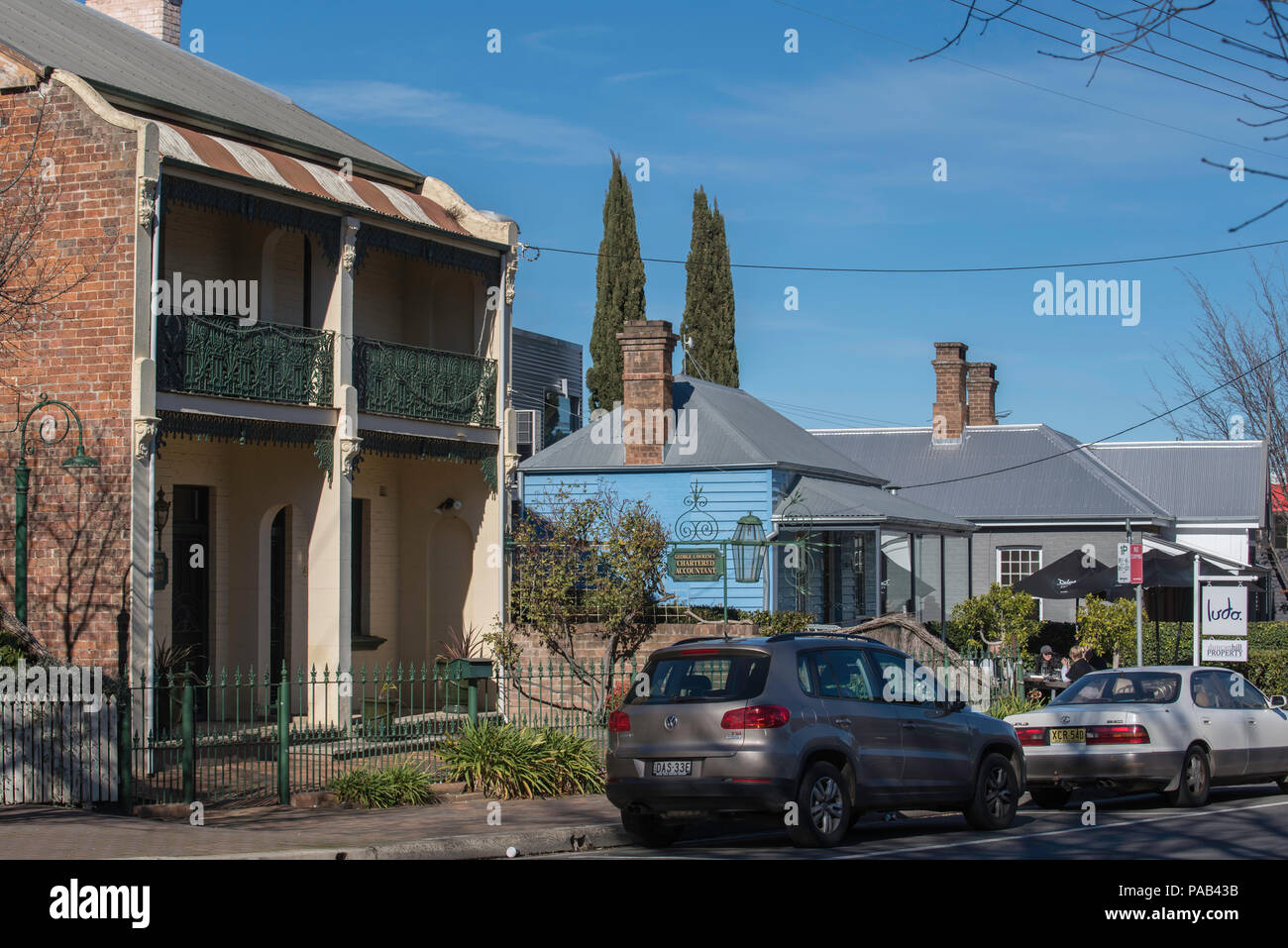 A two storey Victorian terrace house and two other single story cottages now all converted to offices and cafe's in Station Street, Bowral Australia Stock Photo