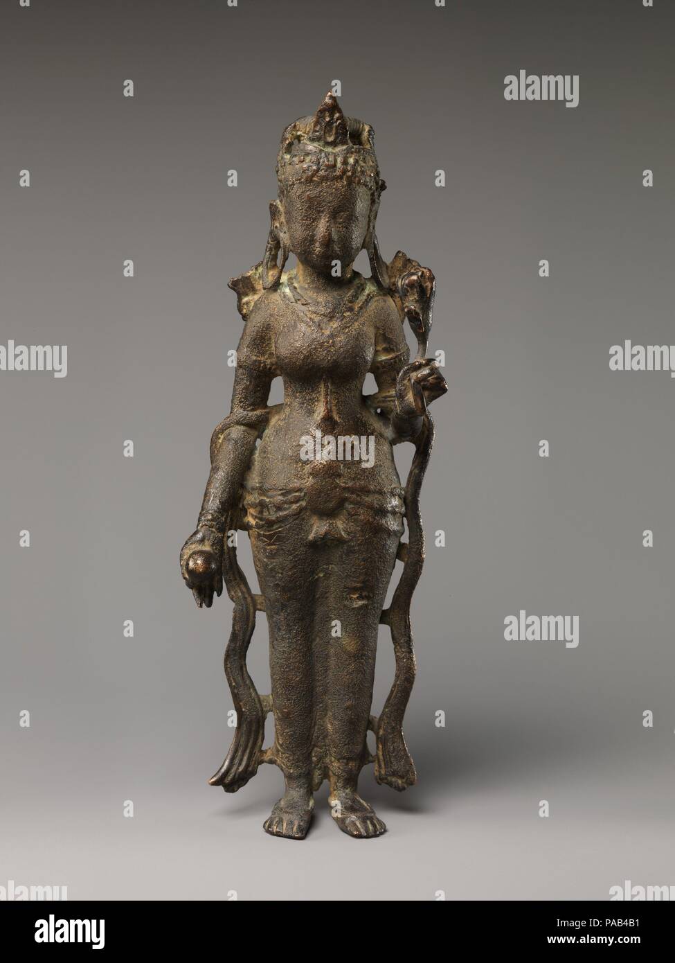 Tara. Culture: North India (possibly Uttar Pradesh). Dimensions: H. 12 in. (30.5 cm). Date: ca. 7th century.  This elegant, full-bodied figure of a Buddhist saviouress holding a long-stemmed lotus suggests affiliations with Avalokiteshvara, the bodhisattva of compassion. The highly modeled jeweled girdle and flowing sashes hanging free of the body point to a seventh-century date, placing her among the earliest representations of Tara known from North India. The closest analogy is a bejeweled Gaja Lakshmi depicted on a copper seal with Brahmi script datable to the sixth or seventh century, exca Stock Photo
