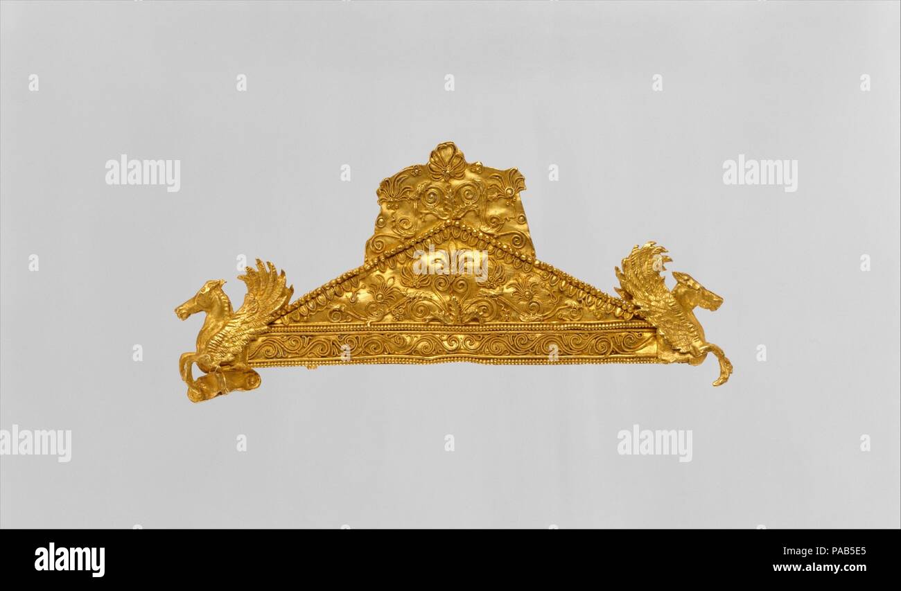 Gold pediment-shaped brooch. Culture: Greek. Dimensions: length  3 1/16in. (7.8cm). Date: ca. 340-320 B.C..  This remarkable object gains most of its effect from the calligraphic use of filigree wire on its large flat surface.  There are now no traces of enamel, but this may well have added the further dimension of color. Museum: Metropolitan Museum of Art, New York, USA. Stock Photo