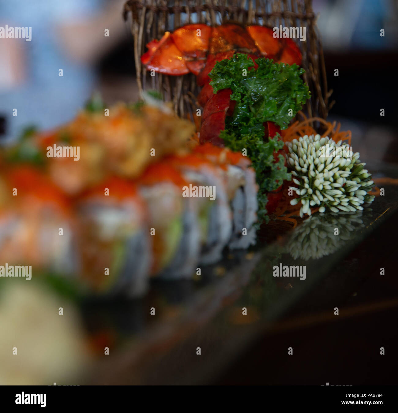 Faded Unknown Sushi Roll with Garnishes Stock Photo