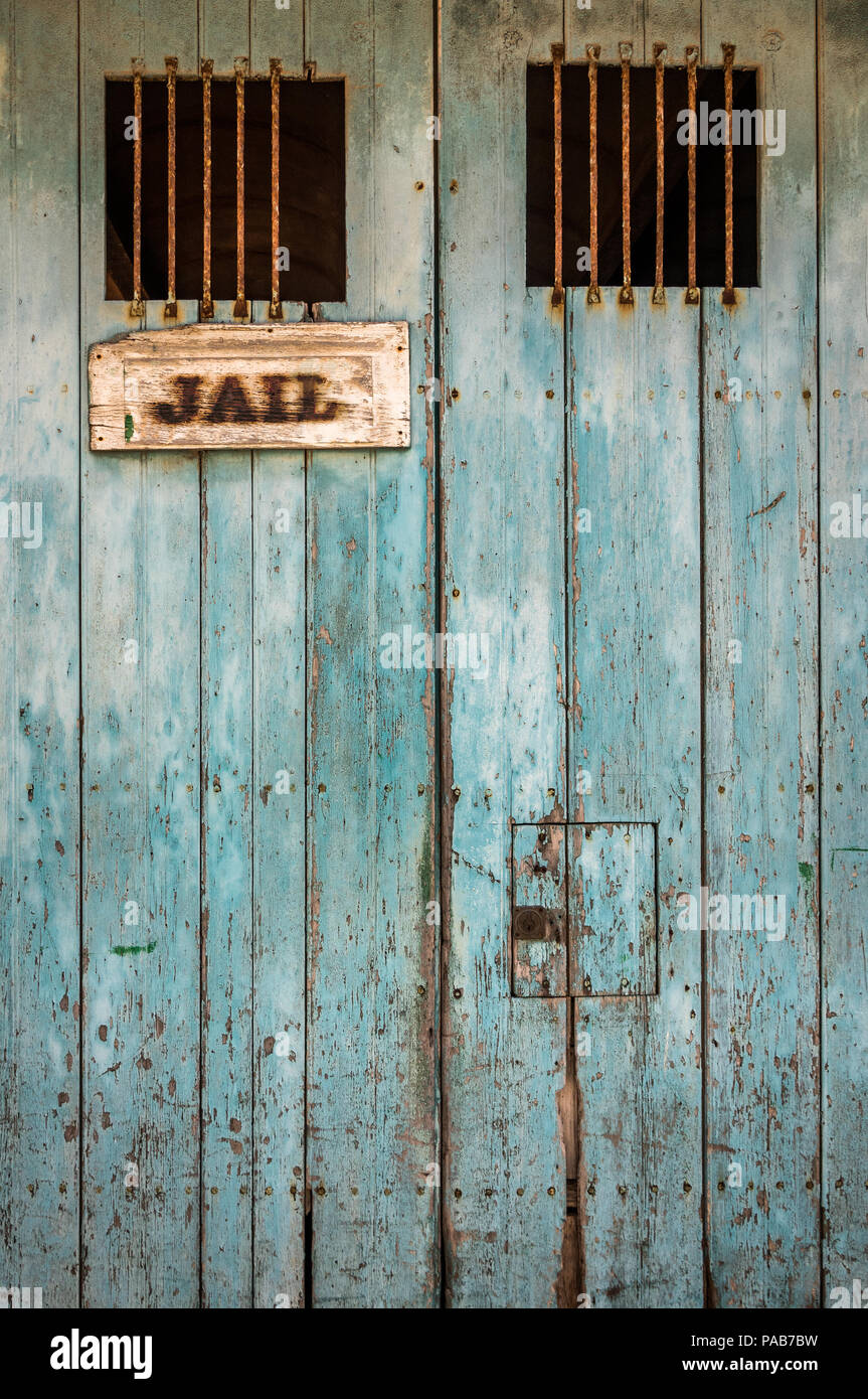 Detail Of A Rustic Jail Door With Bars On The Windows Stock Photo