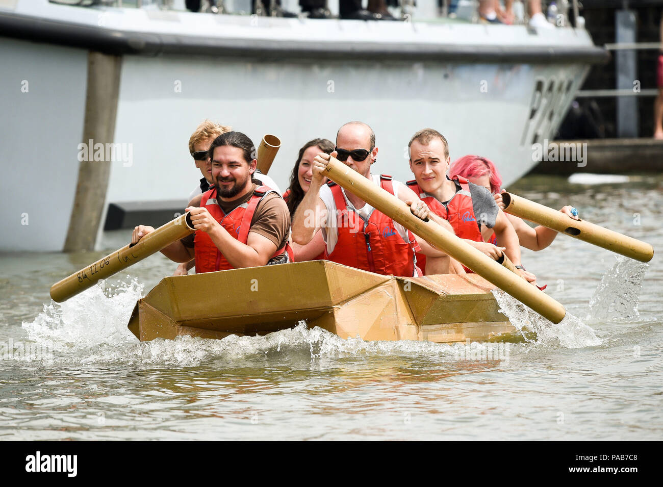 Teams paddle their cardbord boat in a race around Bristol's Floating Harbour, where only