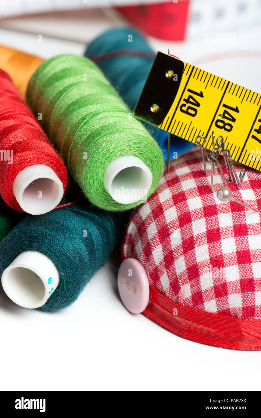 Sewing background with color threads and meter Stock Photo - Alamy