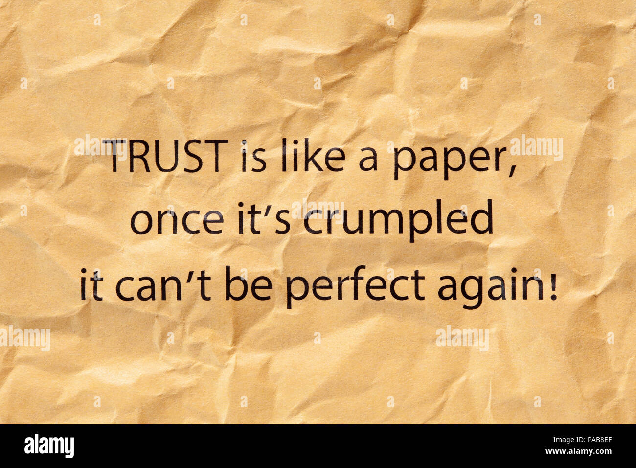 Quote Trust is like a paper, once it's crumpled it can't be perfect again printed on crumpled brown paper. Stock Photo