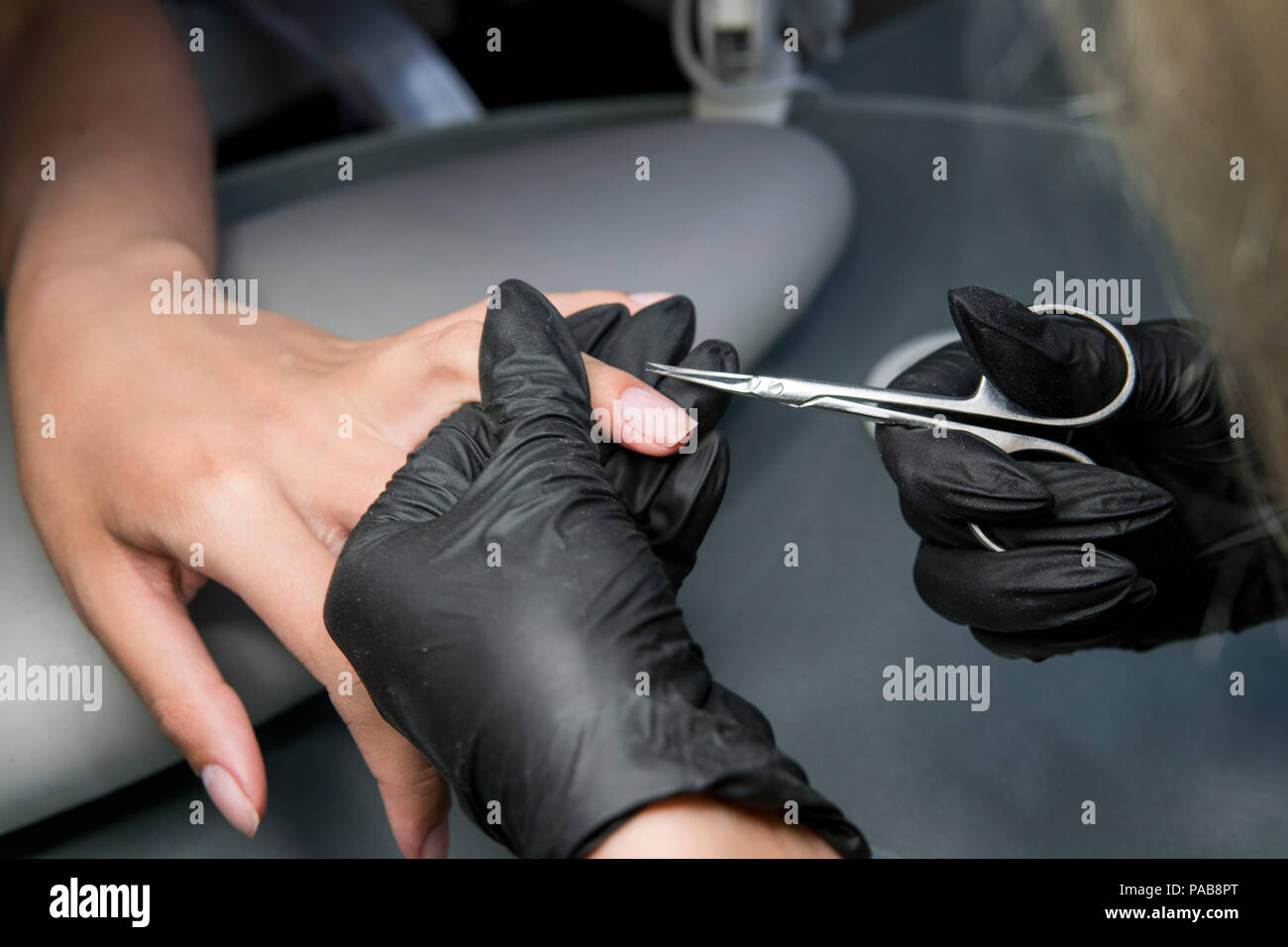 Cutting off the nails cuticle by nail scissors in professional nail