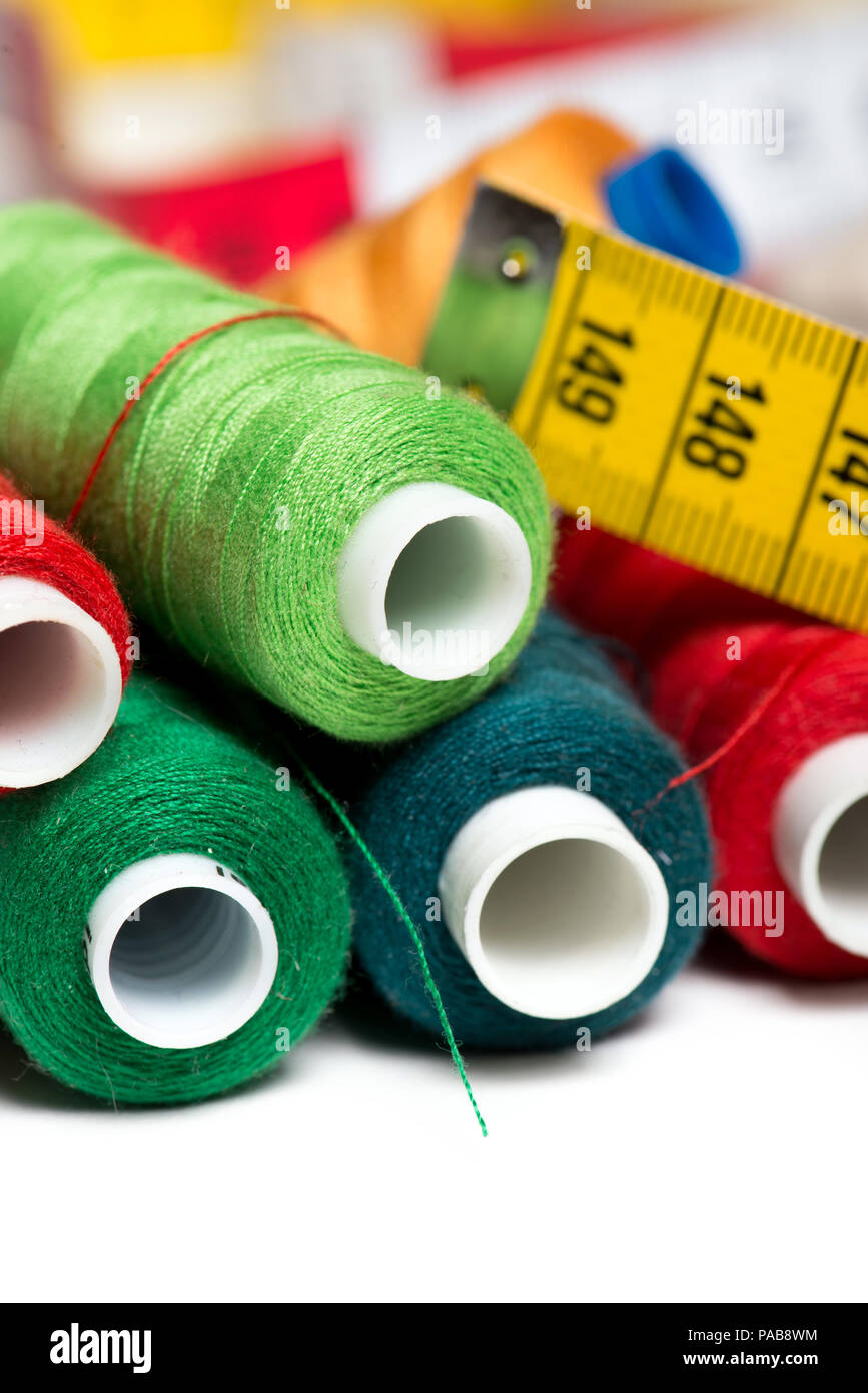 Sewing background with color threads and meter Stock Photo - Alamy