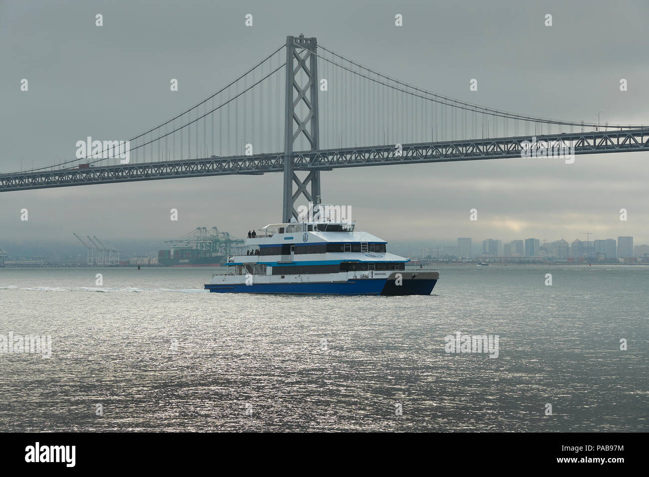 Golden Gate Ferry Arriving At The Ferry Building, The San FranciscoOakland Bay Bridge Behind