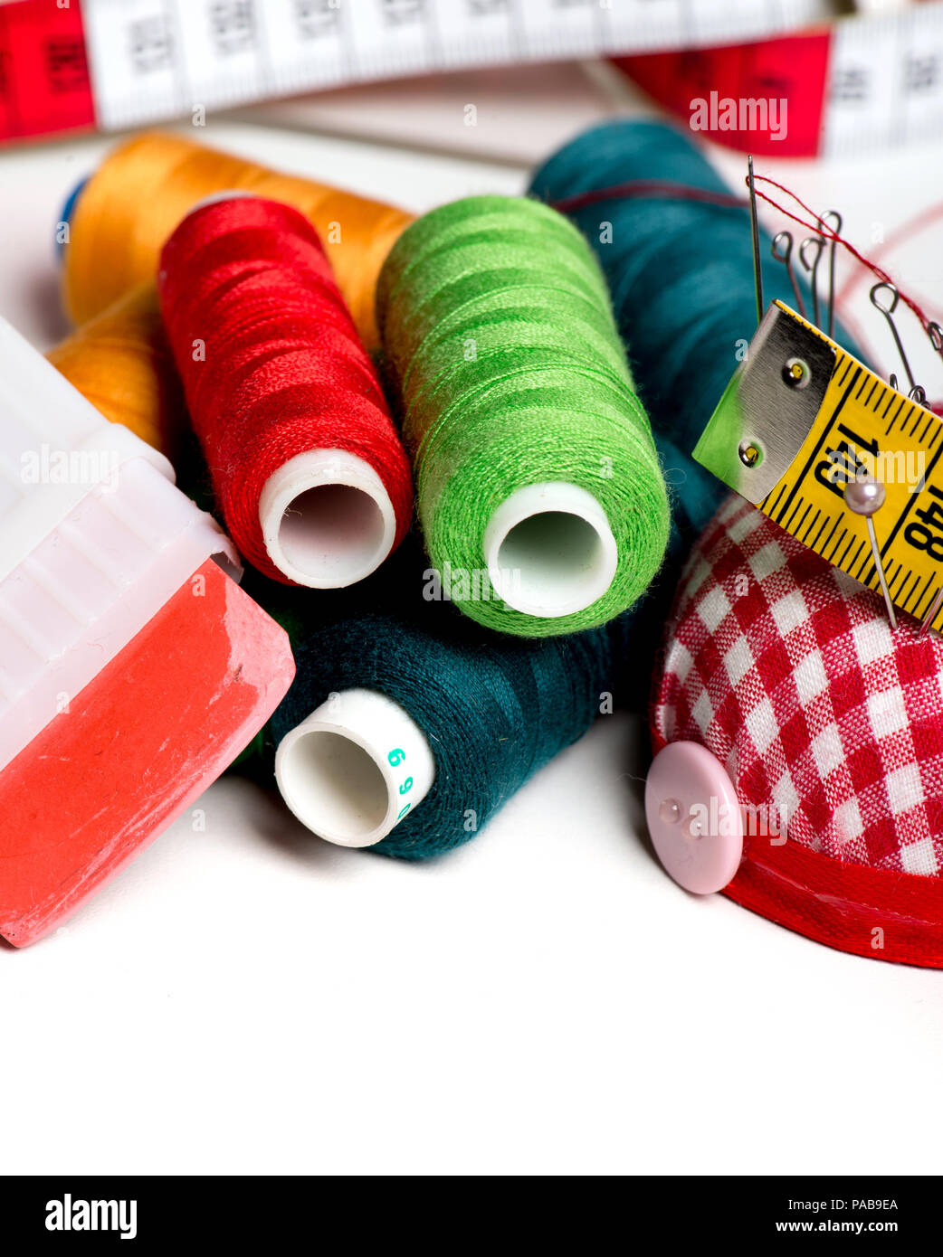 Sewing background with color threads and meter Stock Photo - Alamy