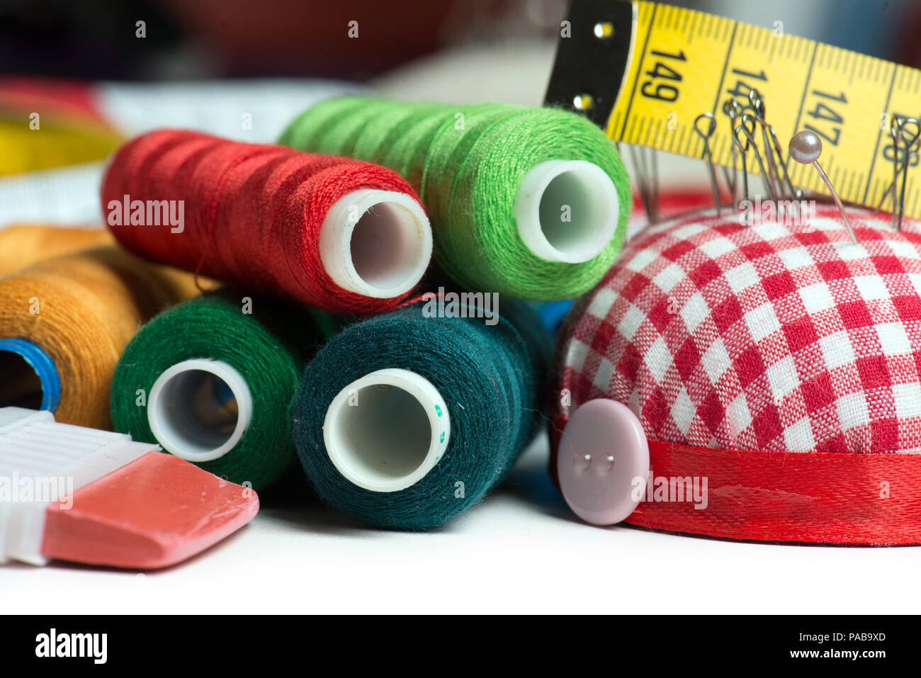 Sewing background with color threads and meter Stock Photo - Alamy