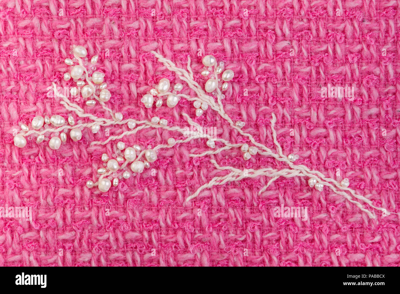 Pearl twig with buds embroidery on fuchsia  tweed clouseup Stock Photo