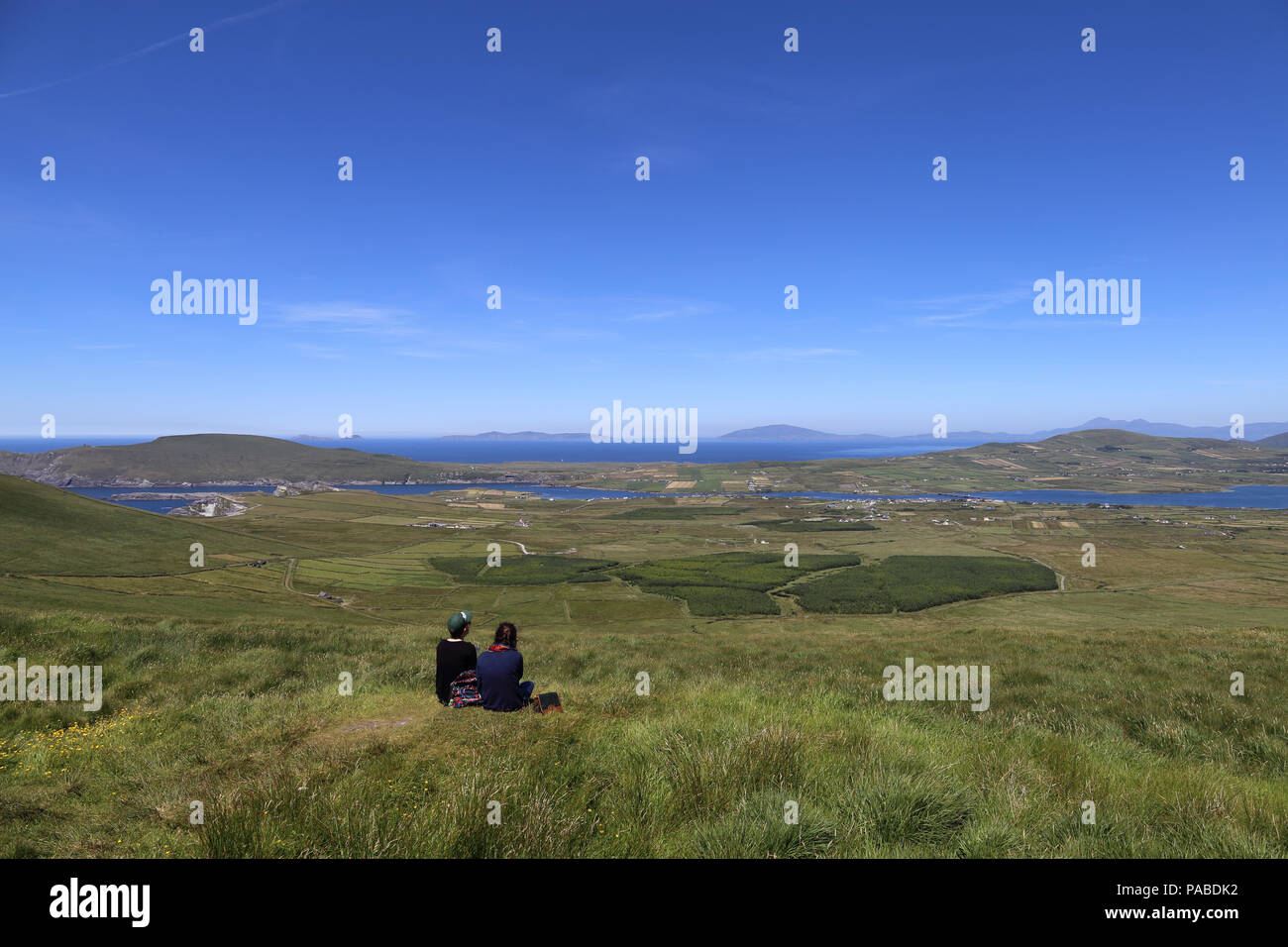 Young travelers enjoying a scenic overlook along the Ring of Kerry, in County Kerry, Ireland. Stock Photo