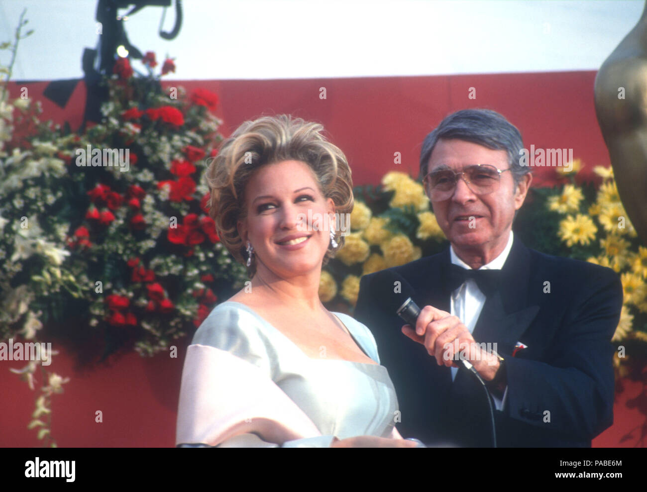 LOS ANGELES, CA - MARCH 30: Singer Bette Midler ad Army Archerd attend the 64th Annual Academy Awards on March 30, 1992 at the Dorothy Chandler Pavilion in Los Angeles, California. Photo by Barry King/Alamy Stock Photo Stock Photo