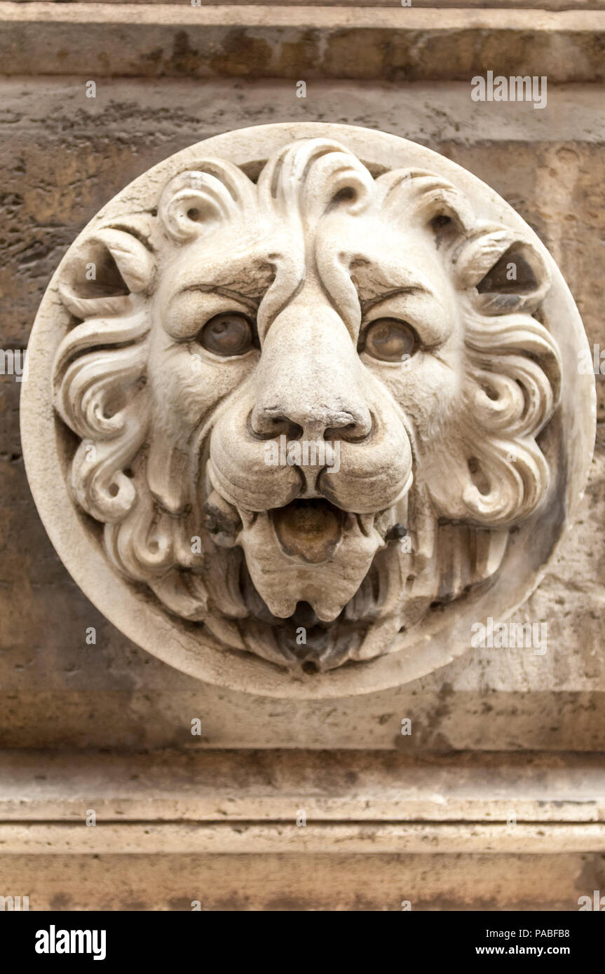 A carved lion's head stares out from a plinth at the Palazzo Barberini in Rome Stock Photo