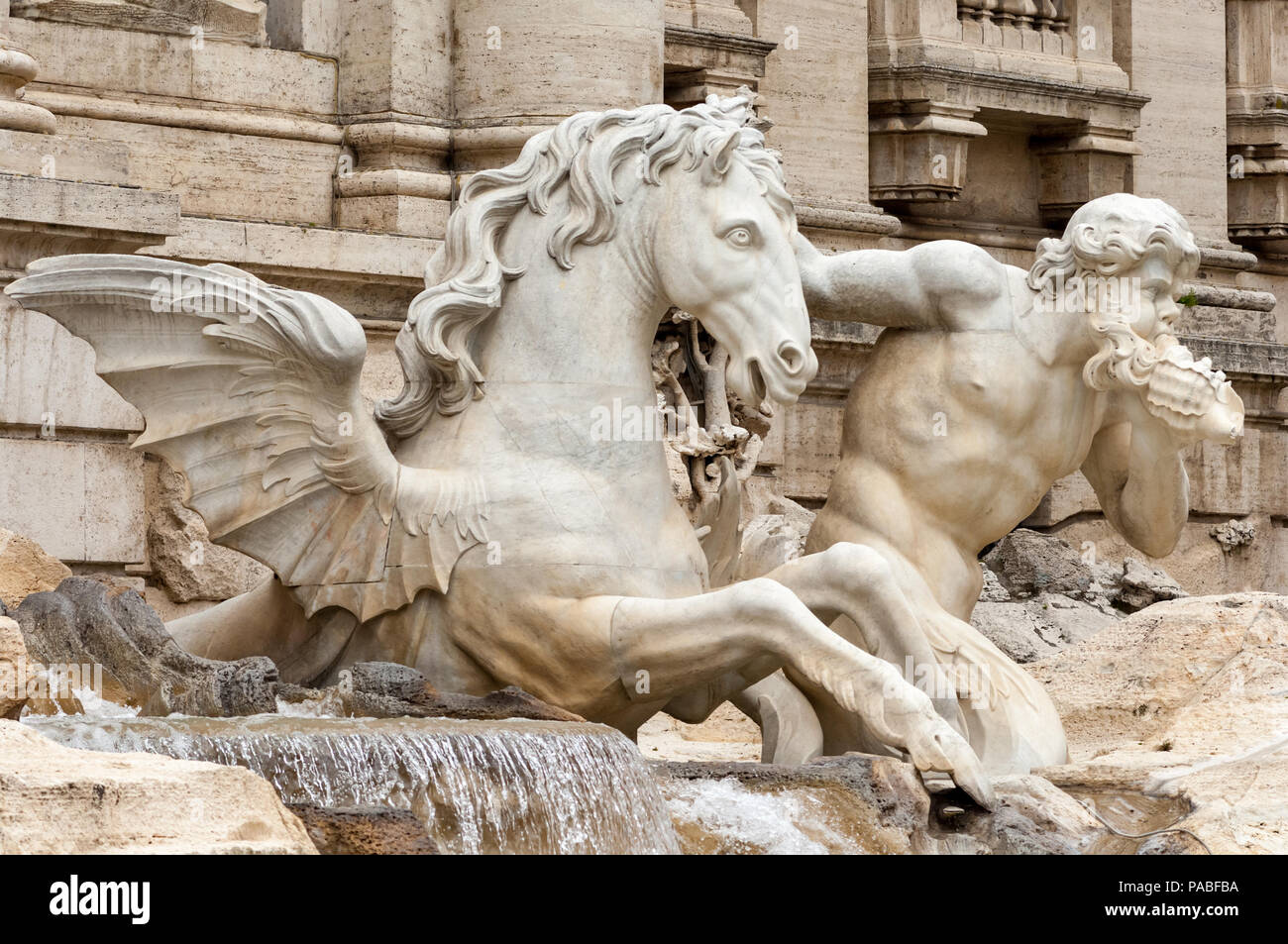 A mythological Triton guides a Hippocamp pulling Oceanus's chariot in the Trevi Fountain in Rome Stock Photo
