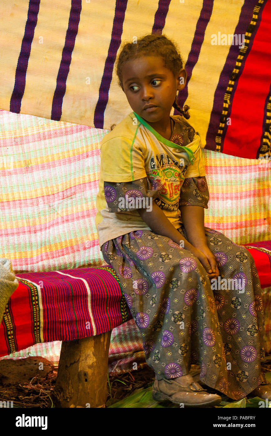 OMO, ETHIOPIA - SEPTEMBER 20, 2011: Unidentified Ethiopian beautiful little girls wearing the traditional bright color clothes. People in Ethiopia suf Stock Photo