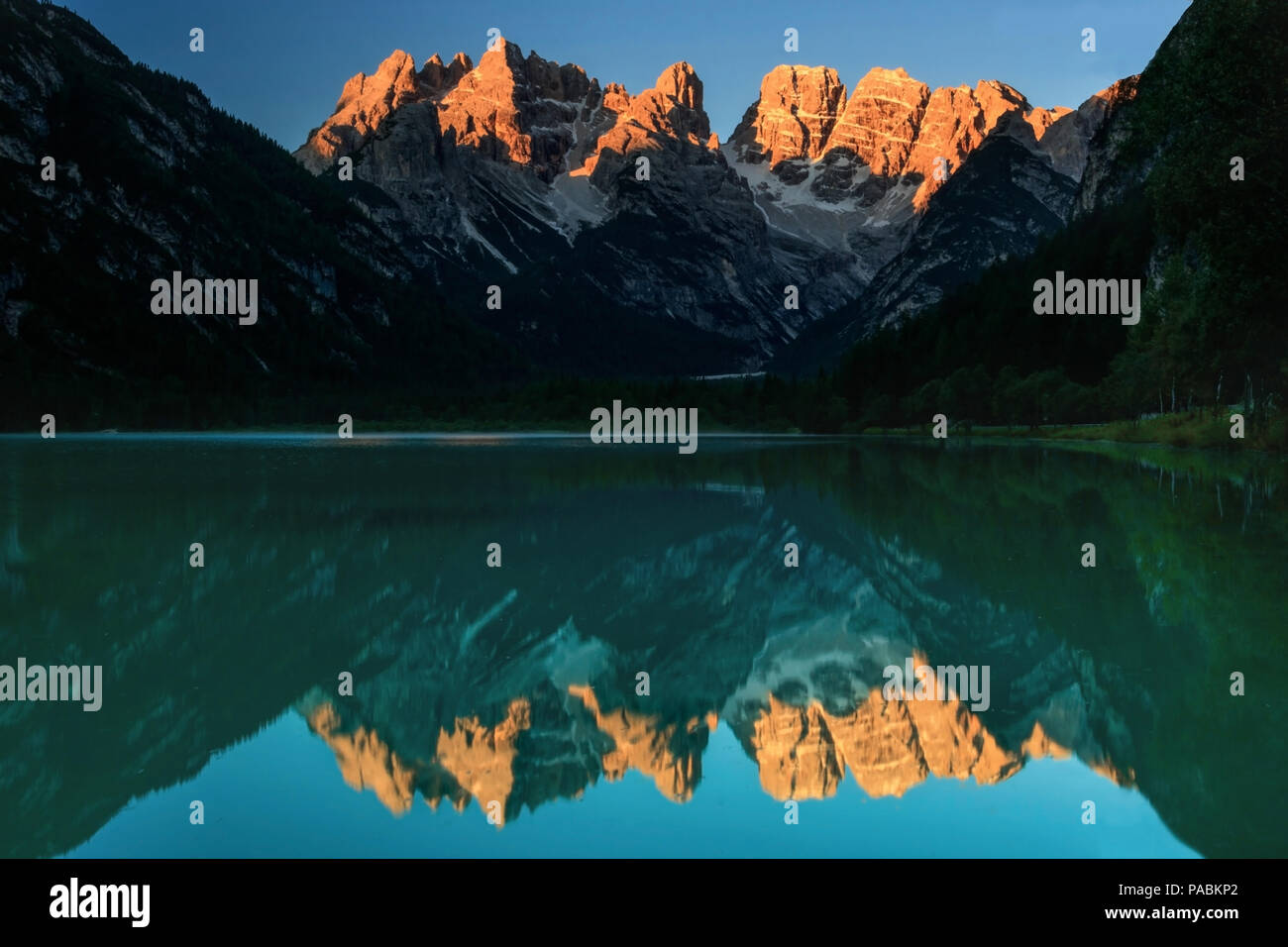 Lago di Landro / Dürrensee with perfect reflection and alpine glow Stock Photo
