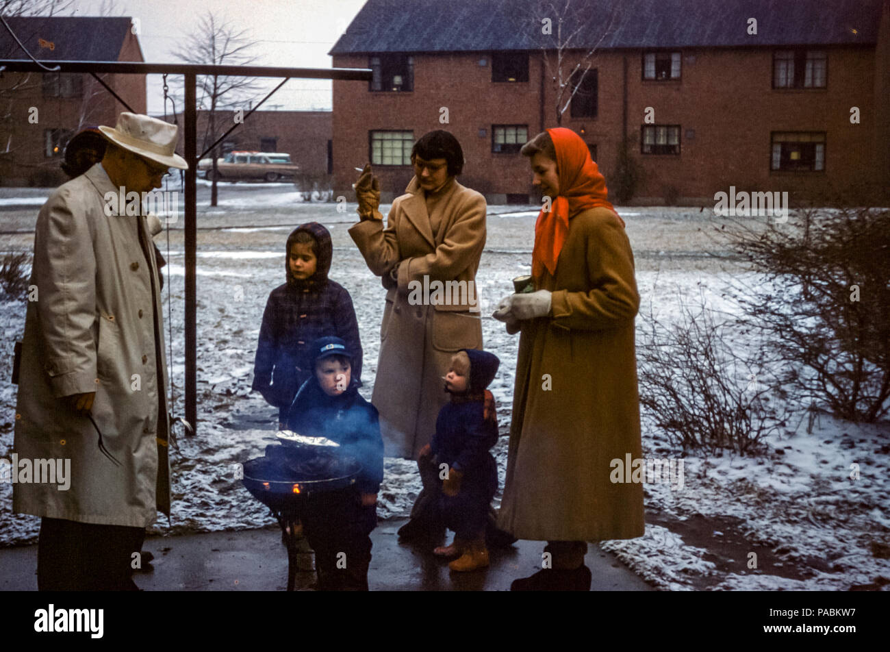 People in housing community having a barbecue in Winter, Buffalo, New York, USA in 1950s Stock Photo