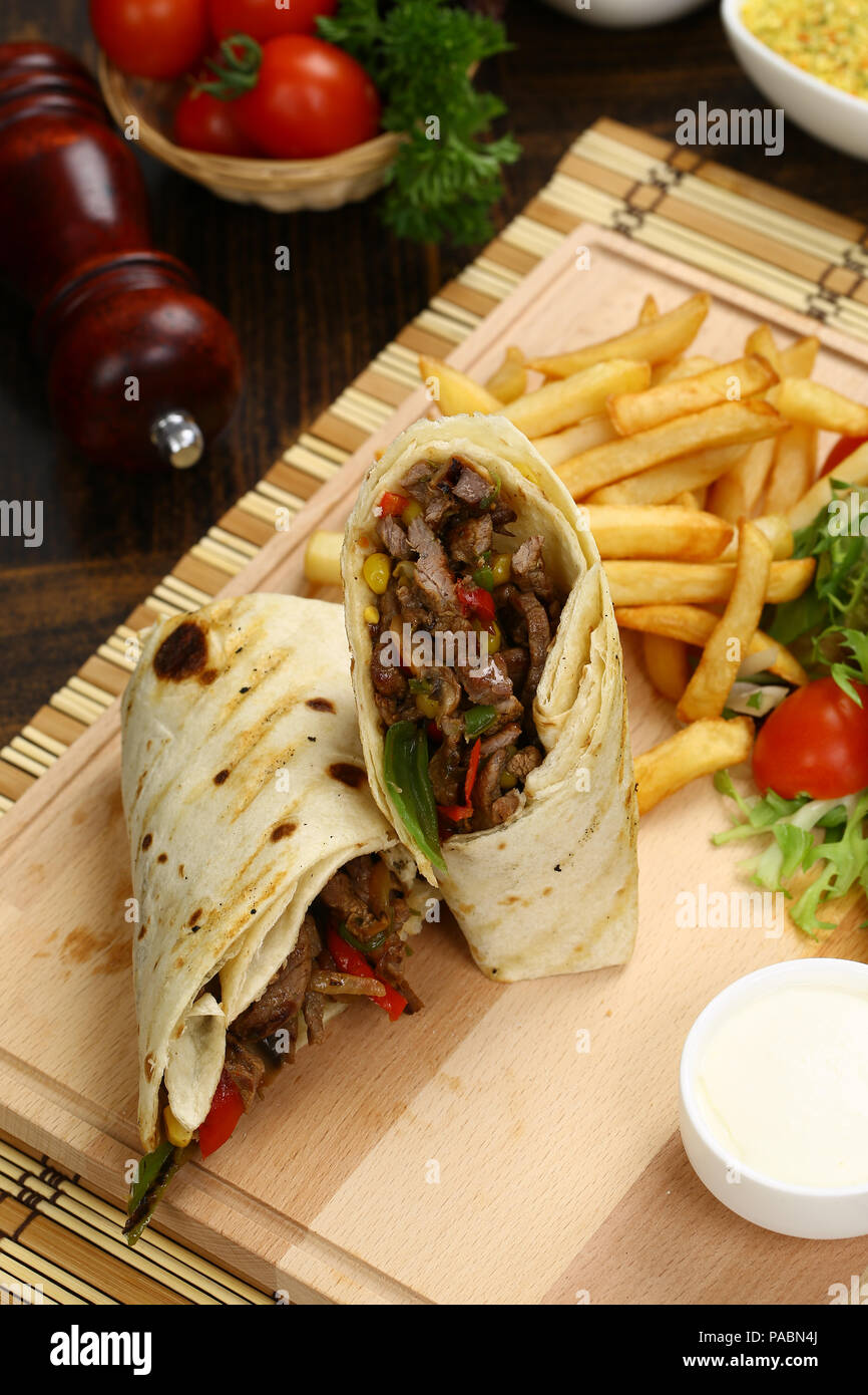 Tortilla wrap with beef meat and french fries Stock Photo - Alamy