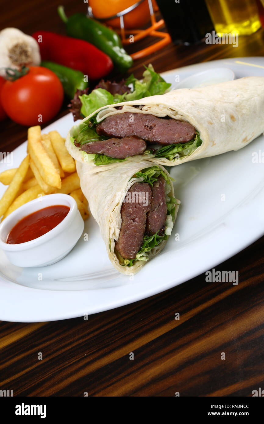 Tortilla wrap with beef meat and french fries Stock Photo - Alamy