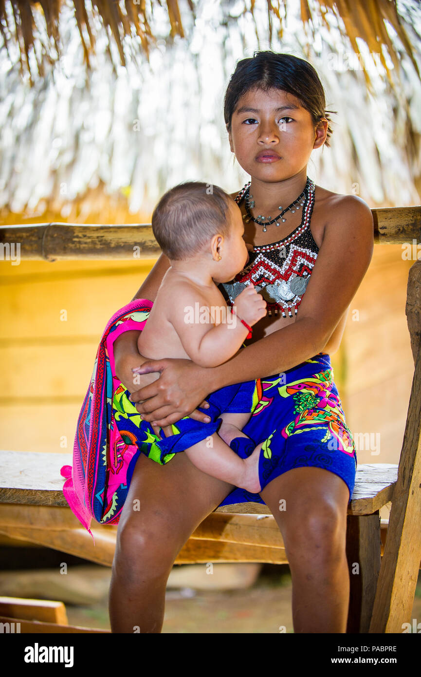 litte panama girl EMBERA VILLAGE, PANAMA, JANUARY 9, 2012: Unidentified native Indian girl  holds her little sister in Panama, Jan 9, 2012. Indian reservation is the  way Stock Photo - Alamy