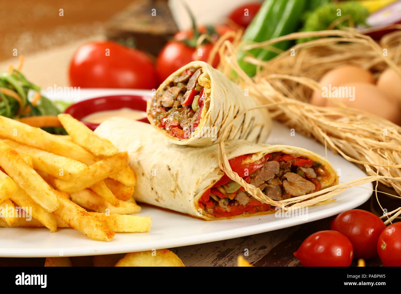 Tortilla wrap with beef meat and french fries Stock Photo - Alamy