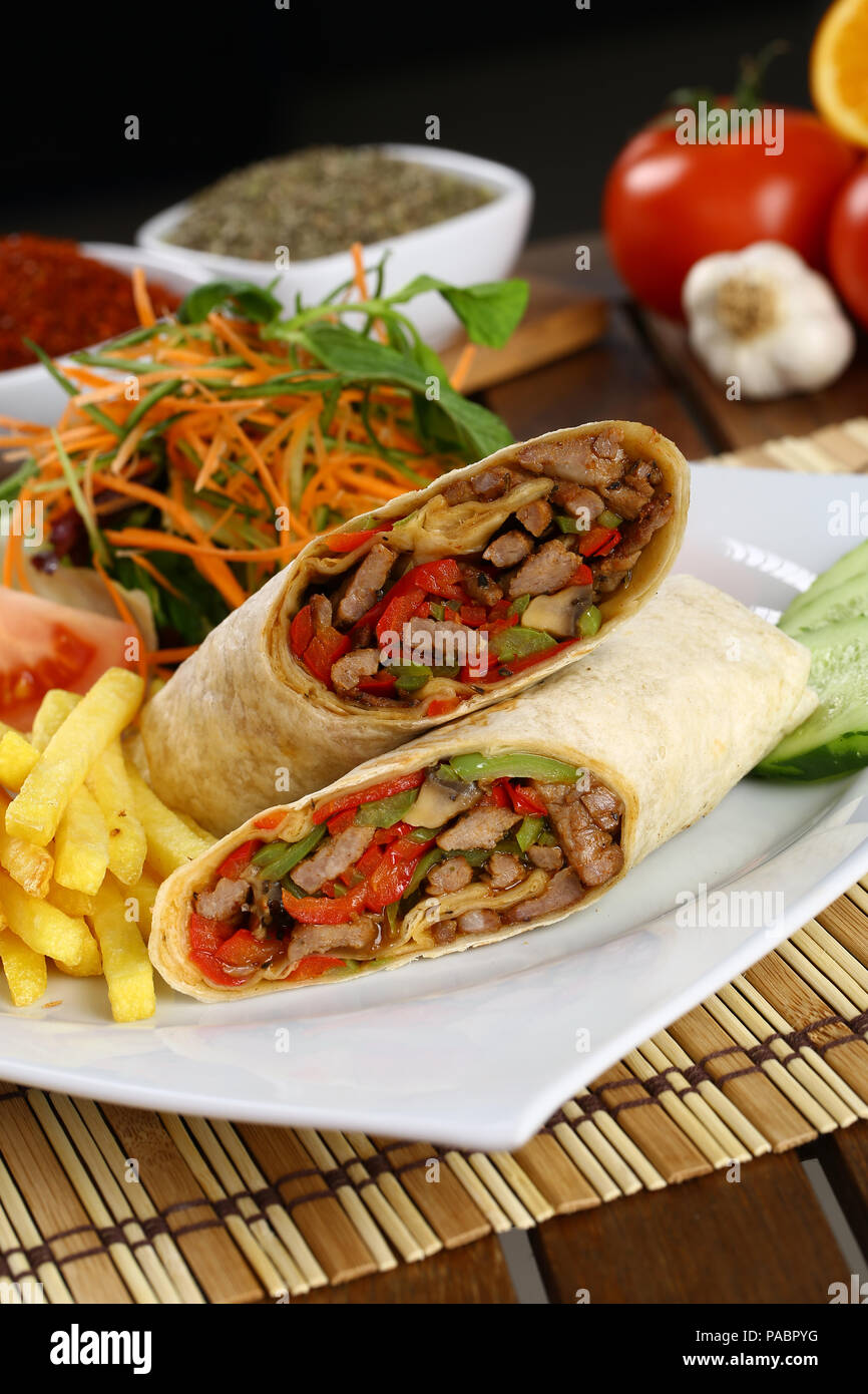 Tortilla wrap with beef meat and french fries Stock Photo - Alamy