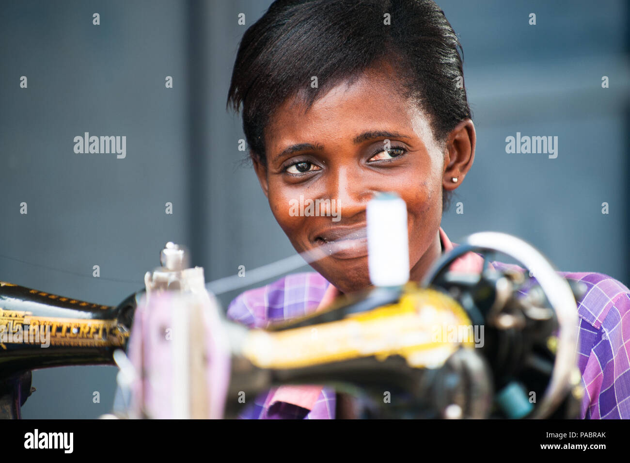 GHANA MARCH 2, 2012 Unindentified Ghanaian woman works with a sewing