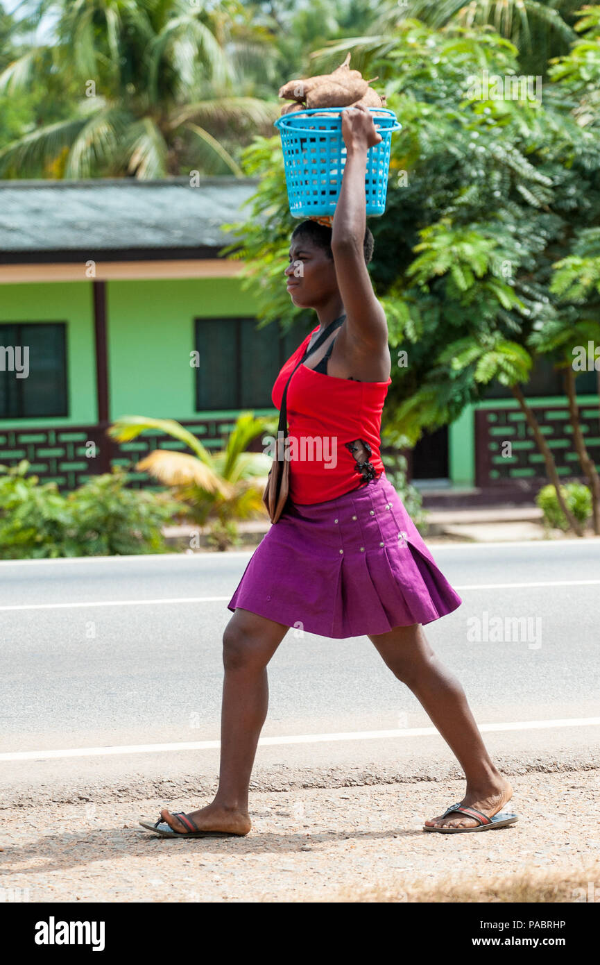 ACCRA, GHANA MARCH 2, 2012 Unidentified Ghanaian girl carries some