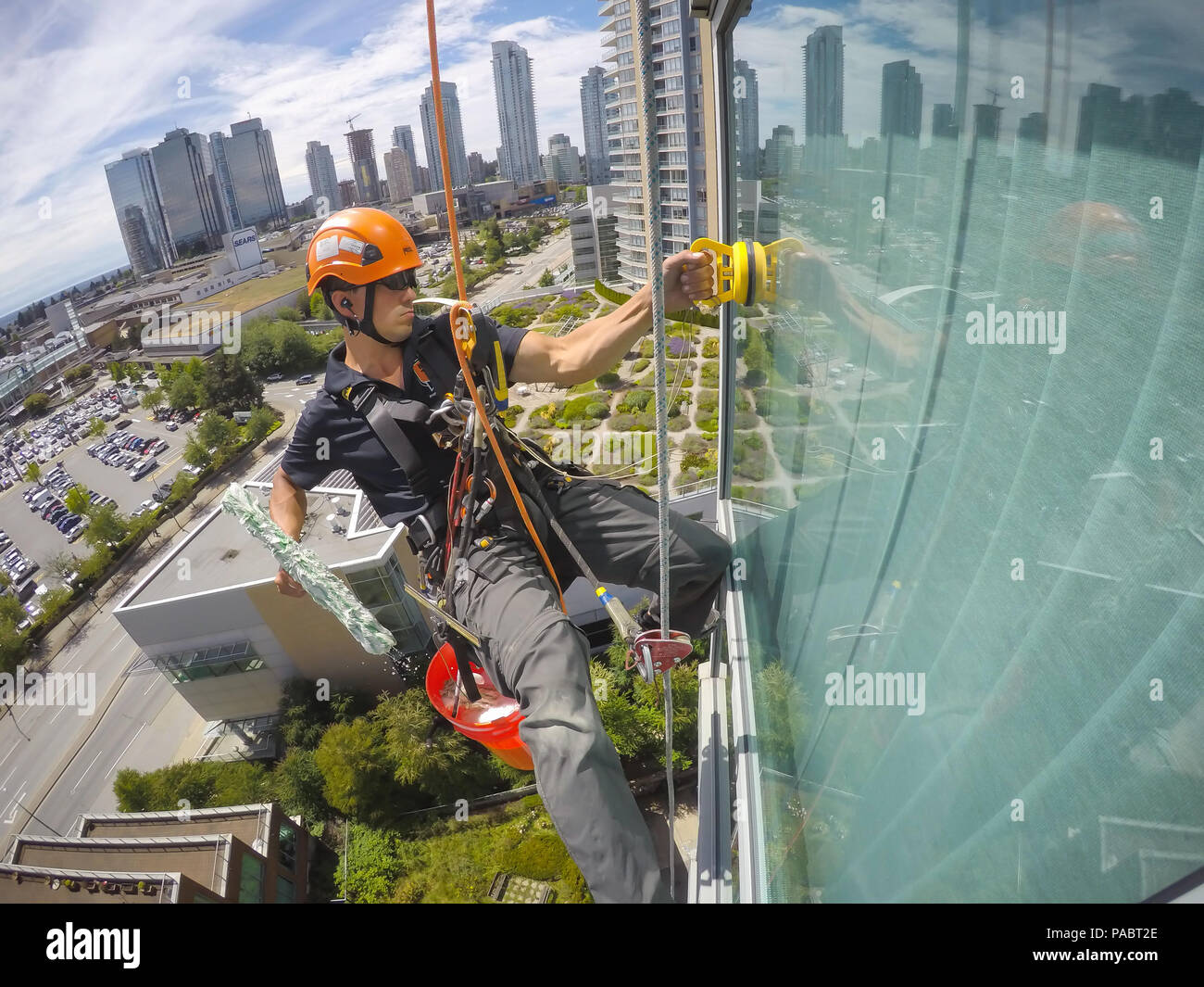 https://c8.alamy.com/comp/PABT2E/burnaby-greater-vancouver-british-columbia-canada-june-17-2018-high-rise-window-cleaner-is-hanging-on-the-side-of-the-building-and-working-PABT2E.jpg