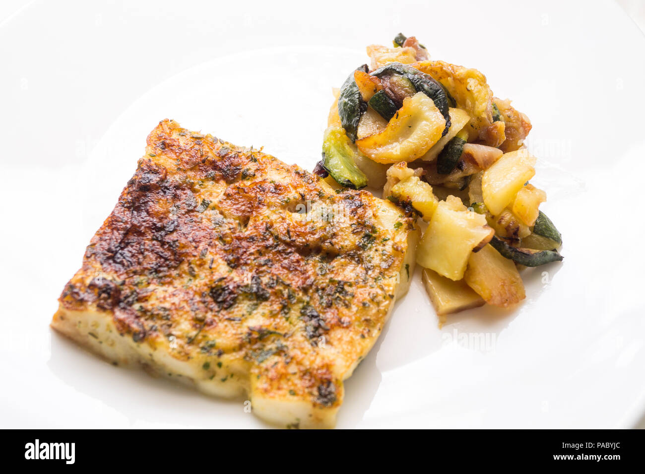 fried fish in the plate with vegetable Stock Photo
