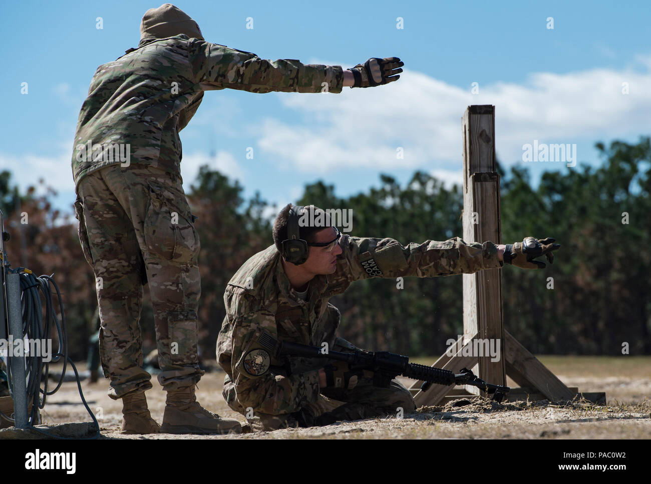 U.S. Air Force Staff Sgt. Sandra Welch, 1st Combat Camera Squadron, combat aerial photojournalist and range safety officer instructs Senior Airmen Nicholas Priest, 1 CTCS Combat broadcaster, during Exercise Scorpion Lens 2016, March 2, 2016, at Fort Jackson, S.C. Exercise Scorpion Lens is an annual Ability To Survive and Operate training evolution mandated by Air Force 3N0XX Job Qualification Standards (3N0XX AFJQS). Individuals are instructed using a 'crawl, walk, run' format of training. The exercise is twofold containing the Scorpion Lens portion, dedicated to Advanced Weapons and Tactical  Stock Photo