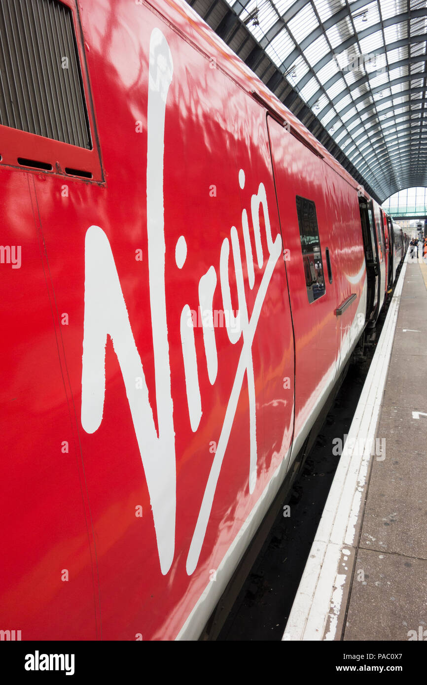 A Virgin Train logo on the side of a locomotive at Kings Cross Railway Station, London, UK Stock Photo