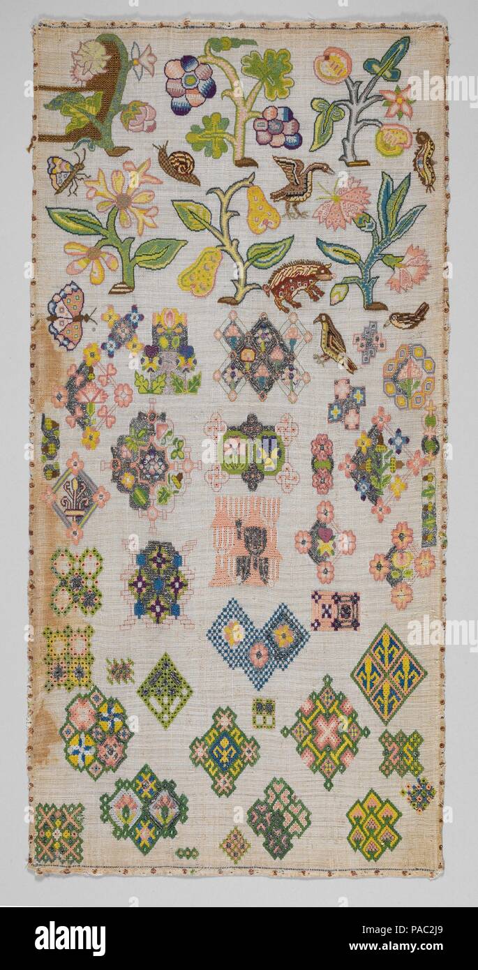 Sampler. Culture: British. Dimensions: H. 21 3/4 x W. 10 5/8 inches (55.2 x 27 cm); Framed: H. 22 3/8 x W. 11 3/8 x D. 1 inch (56.8 x 29.2 x 2.5 cm). Date: mid-17th century.  The canvas ground of this spot sampler is a crowded, asymmetrical flurry of ornamental designs; these include fauna, such as birds, snails, a boar, and butterflies; a variety of fantastic flora in the form of flowering and fruiting branches and stylized blossoms known as slips; and geometric interlacing patterns similar to those of newly fashionable 'knot' parterres, designs for which were first published in England by Th Stock Photo