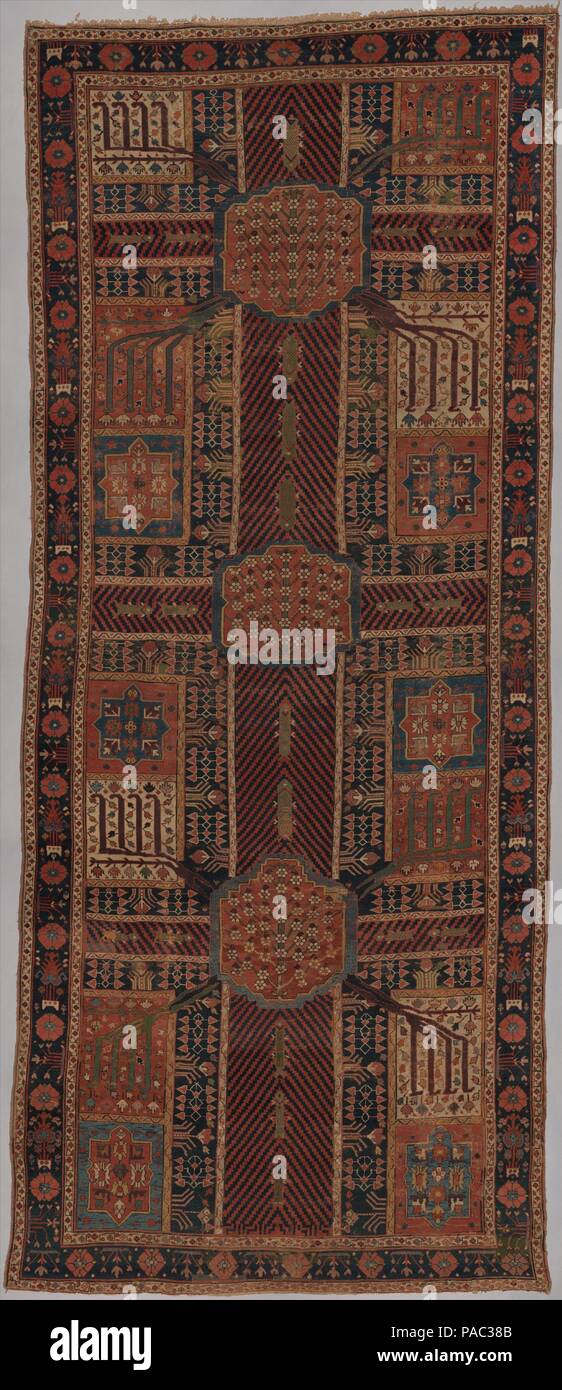 Garden Carpet. Dimensions: Rug: H. 223 1/2 in. (567.7 cm)  W. 95 in. (241.3 cm). Date: ca. 1800.  The earliest Persian garden carpets date from the seventeenth century. This example from Kurdistan or northwestern Iran dates from about 1800. The composition comprises two repeats of the classic Islamic garden plan, known as 'Four Gardens' (Chahar Bagh). It shows a wide central stream of water intersected by narrower courses, all of them enlivened by fish. The units separated by the streams represent ornamental pools or flowerbeds, and the composition as a whole abounds with flowering plants, shr Stock Photo
